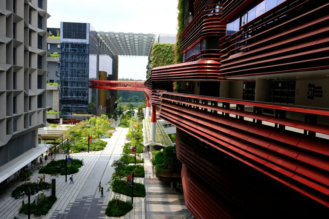 Exterior view of a modern Lentor condominium with greenery and urban walkway